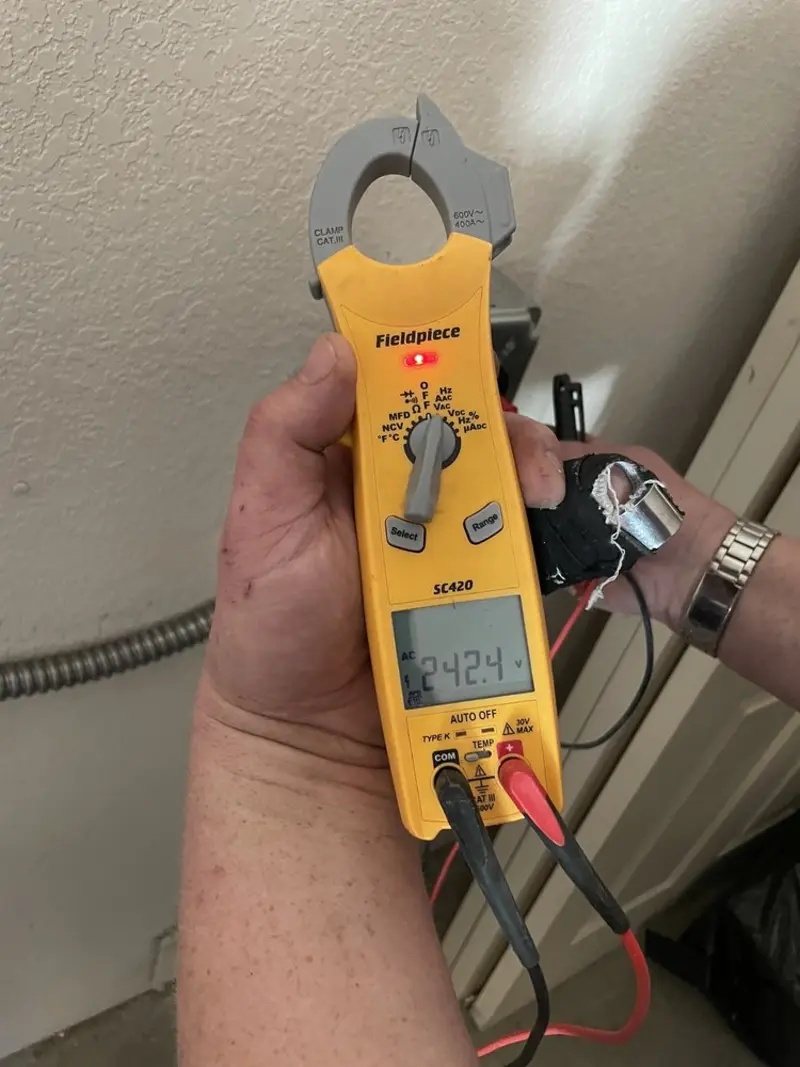 Voltage testing with clamp meter during Ceiling Fan Installation in Lynnwood